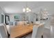 Open dining room with modern table and chairs, adjacent to living area and stylish kitchen at 33 Peterlee Ct, Kissimmee, FL 34758