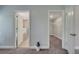 A view of the hallway leads to the bathroom and a walk-in closet with wire shelving at 33 Peterlee Ct, Kissimmee, FL 34758