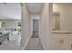 Bright hallway with tile flooring leads to a bedroom, bathroom, and living room with stylish decor at 33 Peterlee Ct, Kissimmee, FL 34758