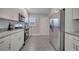 Bright kitchen showcasing stainless steel appliances, granite countertops, and sleek white cabinetry at 33 Peterlee Ct, Kissimmee, FL 34758