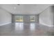 Bright, spacious living room with tile flooring, large sliding glass doors, and neutral color scheme at 33 Peterlee Ct, Kissimmee, FL 34758