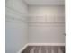 Walk-in closet with carpet flooring, wire shelves, and ample space for storage at 33 Peterlee Ct, Kissimmee, FL 34758