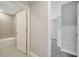 Hallway view of bathroom and bedroom, showcasing neutral color palette and modern design at 35 Peterlee Ct, Kissimmee, FL 34758