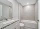 Bathroom features tiled shower-tub combo and granite vanity countertop at 35 Peterlee Ct, Kissimmee, FL 34758