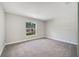 Bedroom featuring carpeted floor, grey walls, white trim and a large window at 35 Peterlee Ct, Kissimmee, FL 34758