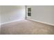 Bright bedroom with neutral carpet and a large window at 35 Peterlee Ct, Kissimmee, FL 34758