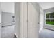 Bright bedroom with carpeted floor, two windows and white doors at 35 Peterlee Ct, Kissimmee, FL 34758