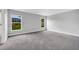 Bright bedroom with two windows and carpeted flooring at 35 Peterlee Ct, Kissimmee, FL 34758