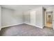 Bedroom with carpeted floor and a white door leading to the hallway at 35 Peterlee Ct, Kissimmee, FL 34758