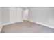 Carpeted bedroom features a closet with bi-fold doors, neutral colors, and ample space at 35 Peterlee Ct, Kissimmee, FL 34758
