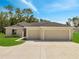 Inviting single-Gathering home featuring a spacious two-car garage, well-manicured lawn, and neutral color palette at 35 Peterlee Ct, Kissimmee, FL 34758