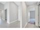 Open hallway with access to bedrooms, featuring neutral paint and tile flooring at 35 Peterlee Ct, Kissimmee, FL 34758