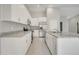 Modern kitchen with white cabinets, stainless steel appliances, granite countertops, and center island at 35 Peterlee Ct, Kissimmee, FL 34758
