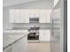 This kitchen has stainless steel appliances, white cabinets and granite countertops at 35 Peterlee Ct, Kissimmee, FL 34758