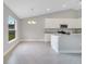 Elegant kitchen featuring granite countertops, white cabinetry, modern appliances, and a dining area at 35 Peterlee Ct, Kissimmee, FL 34758