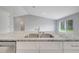 Modern kitchen featuring granite countertops, stainless steel sink and white cabinets at 35 Peterlee Ct, Kissimmee, FL 34758