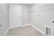 Clean laundry room with tile flooring, a wire shelf and a door at 35 Peterlee Ct, Kissimmee, FL 34758