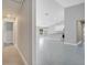 Open-concept living room and kitchen area with gray tile floors and modern white kitchen cabinets at 35 Peterlee Ct, Kissimmee, FL 34758