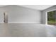 Expansive living area with neutral walls, ceramic tile flooring, and sliding door with a backyard view at 35 Peterlee Ct, Kissimmee, FL 34758