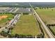 Community aerial view with baseball diamond, playground, athletic fields, a parking area and houses in the background at 355 Churchill Ct, Kissimmee, FL 34759