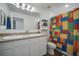 Bright bathroom with double sinks, white cabinets, and a fun Lego-themed shower curtain at 355 Churchill Ct, Kissimmee, FL 34759