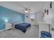 Bedroom with an accent wall, ceiling fan, carpet, and plenty of natural light at 355 Churchill Ct, Kissimmee, FL 34759