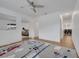 Bright bedroom with airplane themed rug, ceiling fan, and light hardwood floors at 355 Churchill Ct, Kissimmee, FL 34759