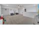 Spacious carpeted bonus room with ceiling fan, seating area, and view of the outdoor scenery on a bright sunny day at 355 Churchill Ct, Kissimmee, FL 34759