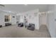 Bonus room featuring carpeted floors, natural light, ceiling fan, and cozy nook with reading materials at 355 Churchill Ct, Kissimmee, FL 34759