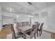 Bright dining area features hardwood floors, modern lighting, and seating for eight at 355 Churchill Ct, Kissimmee, FL 34759