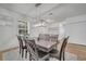 Open dining area features hardwood floors, a modern light fixture, and seating for eight at 355 Churchill Ct, Kissimmee, FL 34759
