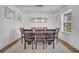 Formal dining room featuring a modern chandelier and ample seating for eight at 355 Churchill Ct, Kissimmee, FL 34759