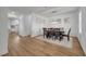 Elegant dining room with modern light fixture, wood flooring, and white walls at 355 Churchill Ct, Kissimmee, FL 34759
