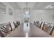 Bright dining room boasts modern light fixture and sleek, dark wood table with seating for eight at 355 Churchill Ct, Kissimmee, FL 34759