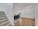 Welcoming entryway features modern light fixture, wood-look floors, and staircase at 355 Churchill Ct, Kissimmee, FL 34759