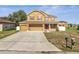 Well-maintained home with a spacious three-car garage and manicured front yard at 355 Churchill Ct, Kissimmee, FL 34759