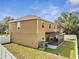 Two-story home featuring a screened lanai, fenced yard, and neutral exterior paint at 355 Churchill Ct, Kissimmee, FL 34759