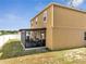 Rear exterior showing a two-story home with screened lanai, and a fenced yard at 355 Churchill Ct, Kissimmee, FL 34759