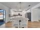 Eat-in kitchen boasts white cabinets, stainless appliances, and a large center island with dining at 355 Churchill Ct, Kissimmee, FL 34759