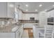 Well-lit kitchen equipped with modern appliances, granite counters, and white cabinets at 355 Churchill Ct, Kissimmee, FL 34759