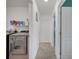 Convenient laundry room with modern machines, storage shelves, and clean white walls at 355 Churchill Ct, Kissimmee, FL 34759