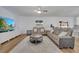 Spacious living room with comfortable seating, a ceiling fan, and a modern TV at 355 Churchill Ct, Kissimmee, FL 34759