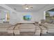 Cozy living room with plush seating, large TV, and view of the outdoor scenery at 355 Churchill Ct, Kissimmee, FL 34759