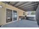 Covered patio with a hot tub, grill, and sliding glass door leading to the home at 355 Churchill Ct, Kissimmee, FL 34759