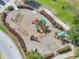 Aerial view of a colorful community playground with slides, swings, and climbing structures for outdoor fun at 355 Churchill Ct, Kissimmee, FL 34759