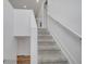 Carpeted staircase features white banister at 355 Churchill Ct, Kissimmee, FL 34759