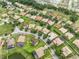 Aerial view of a residential neighborhood with well-maintained lawns, mature trees, and tile roofs at 3856 Shoreside Dr, Kissimmee, FL 34746