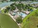 Exceptional aerial view of the community pool area with a clubhouse and lake access at 3856 Shoreside Dr, Kissimmee, FL 34746