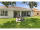 Wide backyard shows the back of the home with a screen patio and well-kept lawn at 3856 Shoreside Dr, Kissimmee, FL 34746