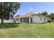 Wide backyard shows the back of the home with a screen patio and well-kept lawn at 3856 Shoreside Dr, Kissimmee, FL 34746